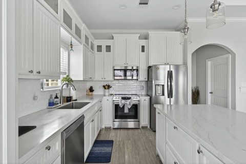 Quartz counters and a farmhouse-style kitchen