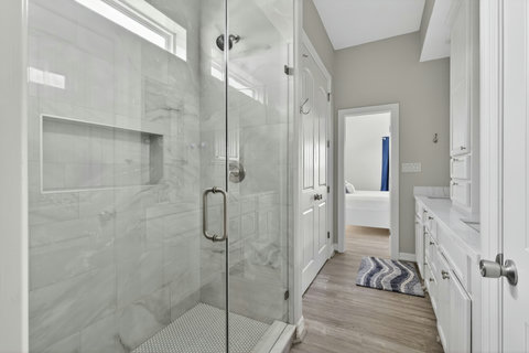 Walk-in glass shower in the bedroom's private bath