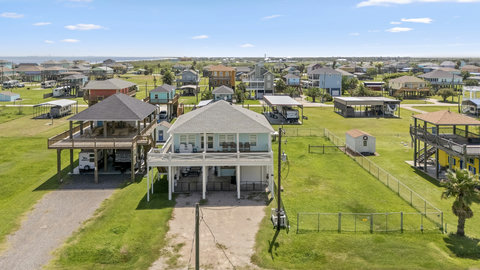 Aerial view of the house and fenced yard
