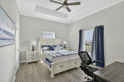 Bedroom with its own bath, a desk and a TV