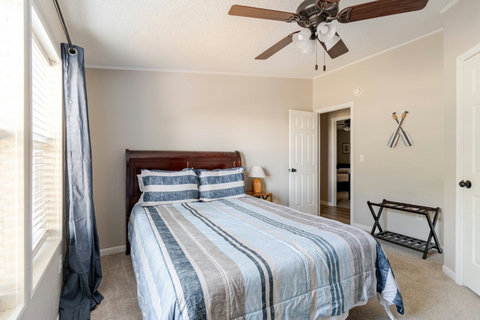 Queen bedroom with soft striped bedding