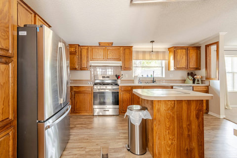 Kitchen with a gas range, island and stainless appliances