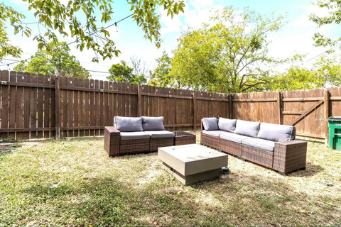 Fenced backyard with outdoor lounge seating