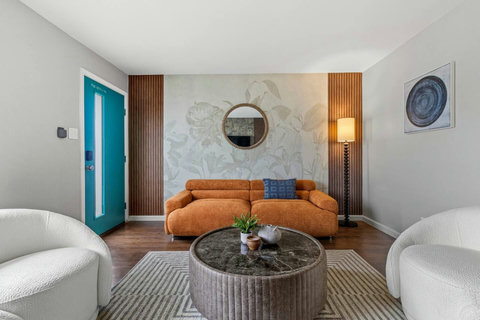 Living room with a teal front door