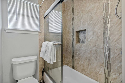 Bathroom with a tub and tile shower