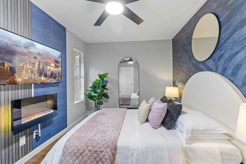 Bedroom with a fireplace and city art