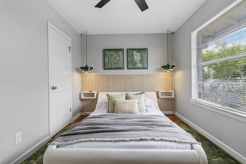 Bedroom with a slatted headboard and pendant lights