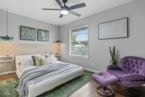 Bedroom with a purple lounge chair