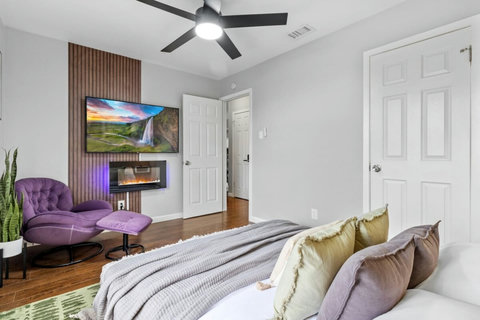 Bedroom with a fireplace and lounge chair