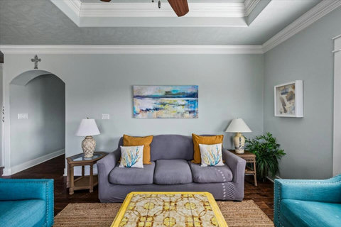 Sofa with coastal art and colorful pillows