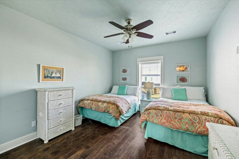 Third bedroom with two beds and colorful quilts