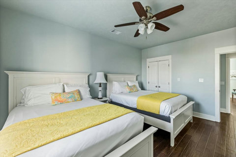 Two beds with sunny yellow throws