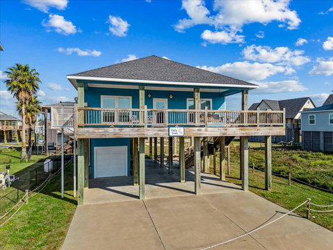 Raised beach house with a long covered deck