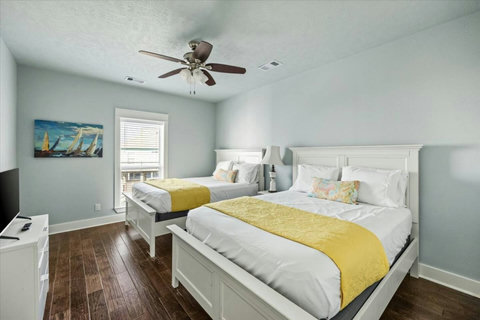 Bedroom with two beds and a TV