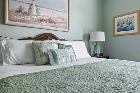 Crisp white linens and soft green quilts