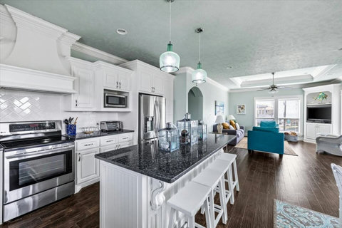 Stainless appliances and a long granite island