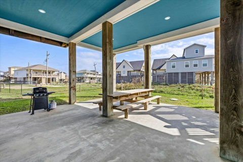 Picnic table and grill under the house