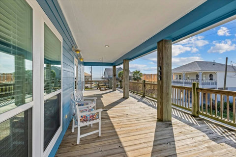 Covered deck with chairs and a view down the street