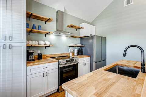Kitchen with open shelves and a stainless range