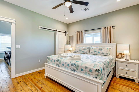 King bedroom with soft coastal bedding