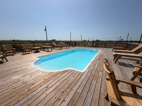 Pool sundeck with Adirondack chairs
