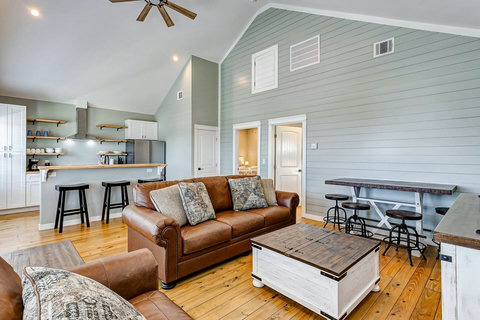 Open living room with leather sofas and vaulted ceilings