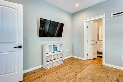 Bunk room with a TV and storage cubes