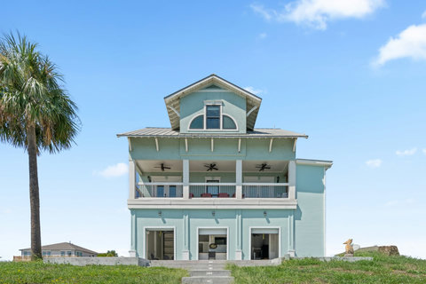 Waterfront home with covered balconies on two levels