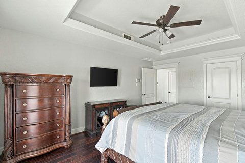 Primary bedroom with a dresser and closet