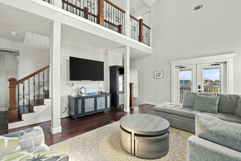 Living room with a smart TV and doors to the balcony
