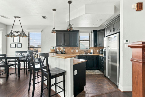 Kitchen with bar seating and dining nearby