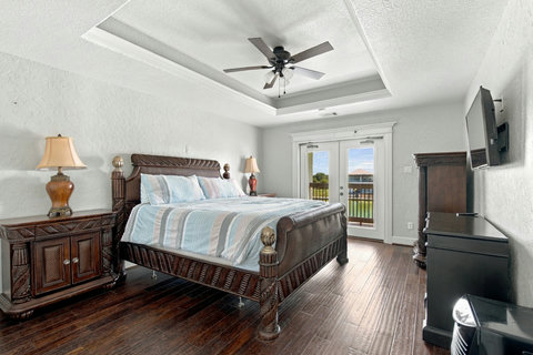 Primary bedroom with French doors to the balcony
