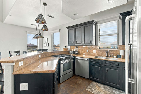 U-shaped kitchen with a stainless fridge
