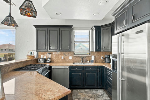 Kitchen with a gas range, granite counters and stainless appliances