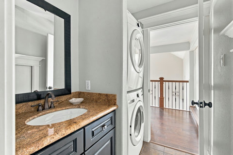 Bath vanity with a stacked washer and dryer