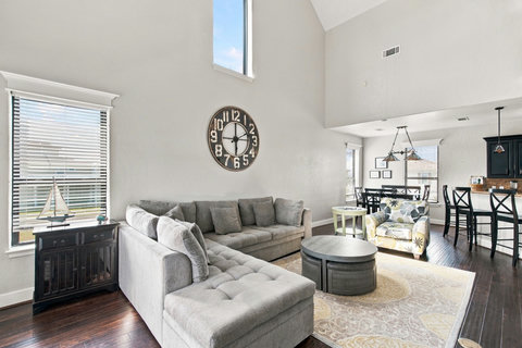 Living room with tall windows and a sectional
