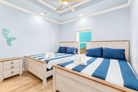 Two queen beds with crisp striped bedding