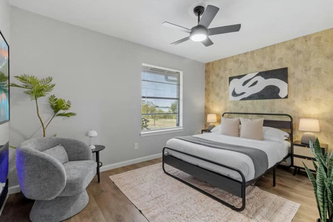 Bedroom with a reading chair and accent wall