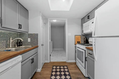 Galley kitchen with a gas range and butcher-block counters