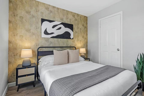 Bedroom with a gold accent wall