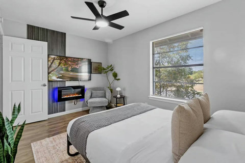 Bedroom with a fireplace and reading chair