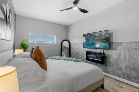 Bedroom with a TV and fireplace