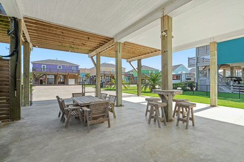 Shaded patio with dining and bar-height tables