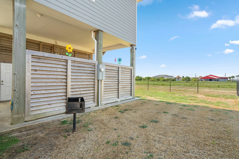 Charcoal grill by the fenced yard