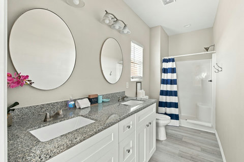 Bath with a double vanity and walk-in shower