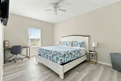 King bedroom with a desk and plenty of room
