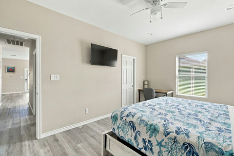 King bedroom with a wall TV