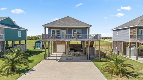 Raised beach house with a covered deck