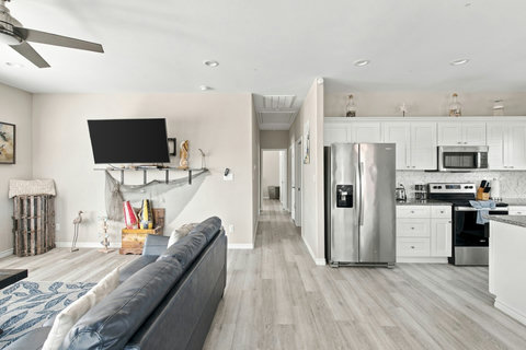 Living room with the kitchen and hallway beyond