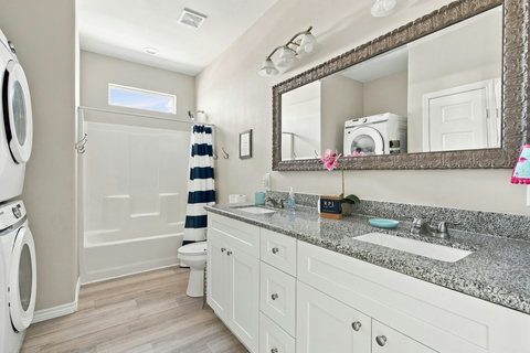 Hall bath with a double vanity and tub-shower